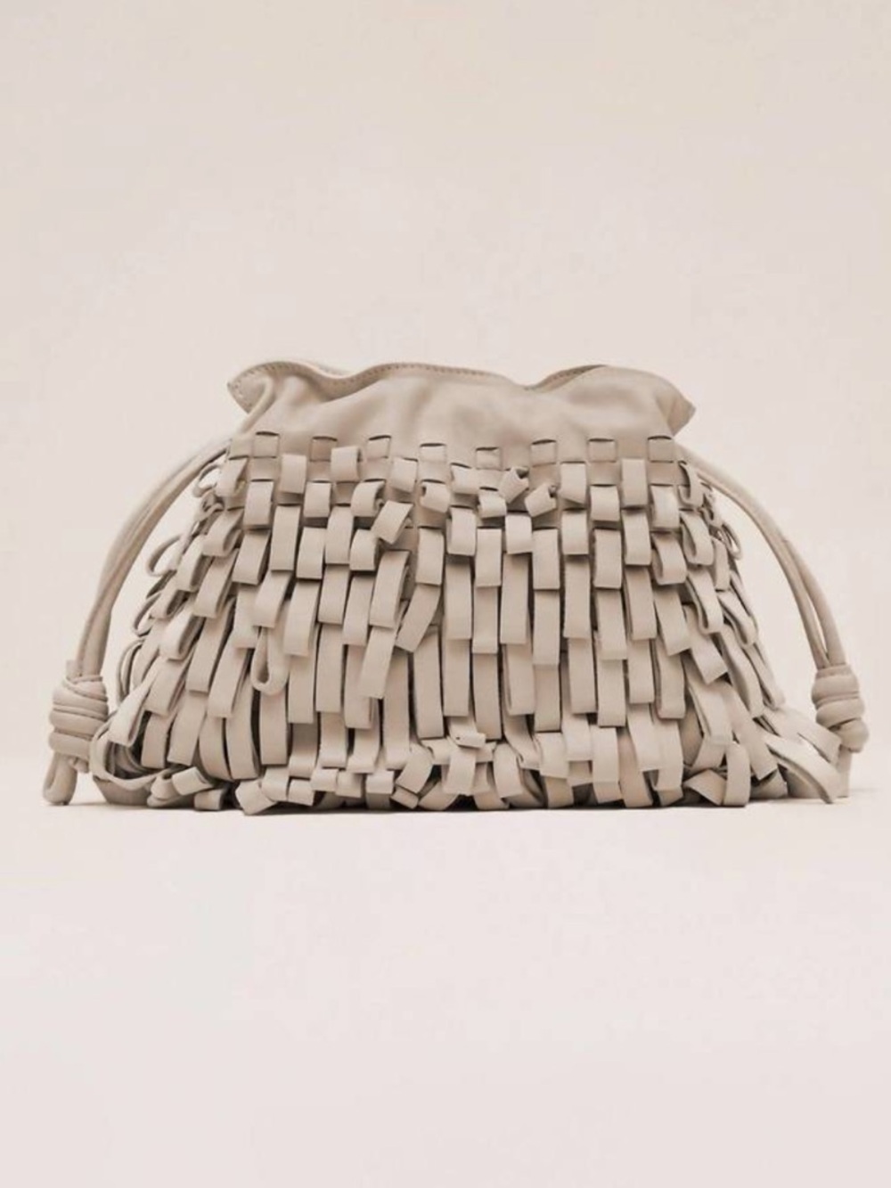 Alexis Quinn Fringe Woven Leather Drawstring Clutch in Vanilla